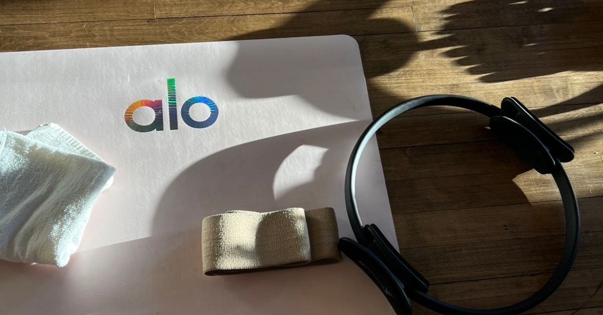 Yoga mat next to headphones and towel creating aesthetic picture for wellness marketing strategies